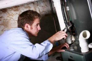 Technician inspecting furnace