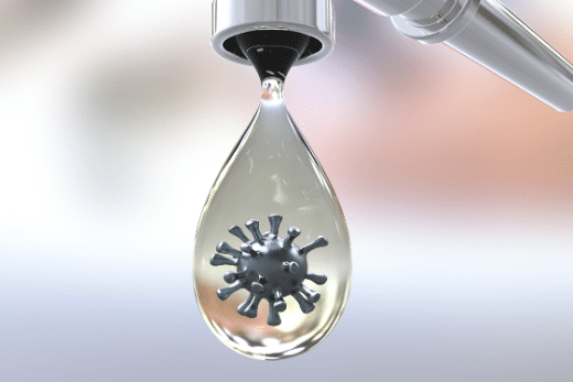 a water droplet coming from a faucet with a toxic particle inside