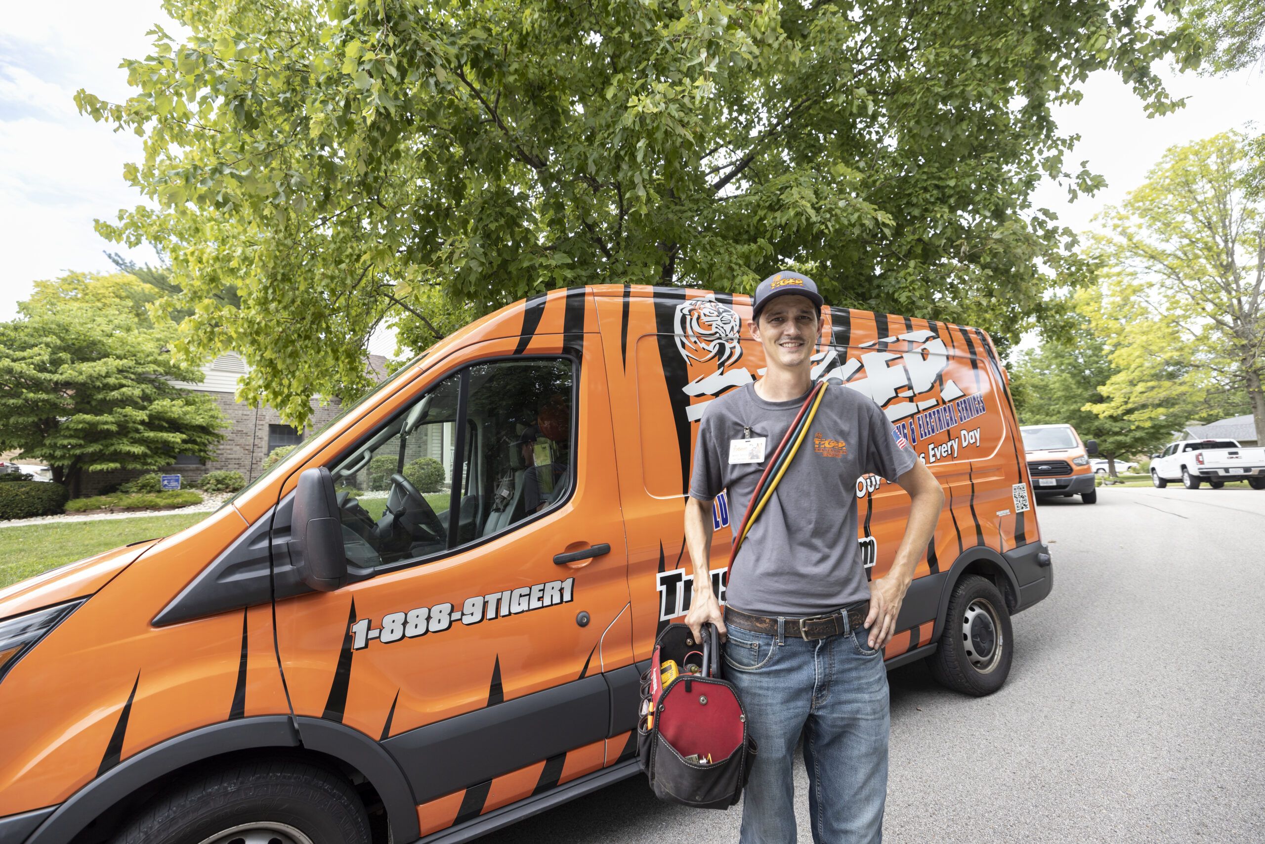 tiger employee in front of a van